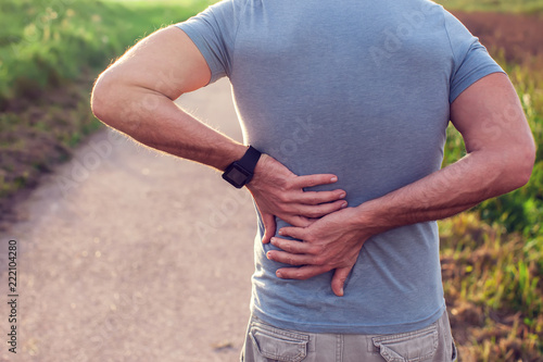 фотографія People, healthcare and problem concept - unhappy man suffering from pain in back