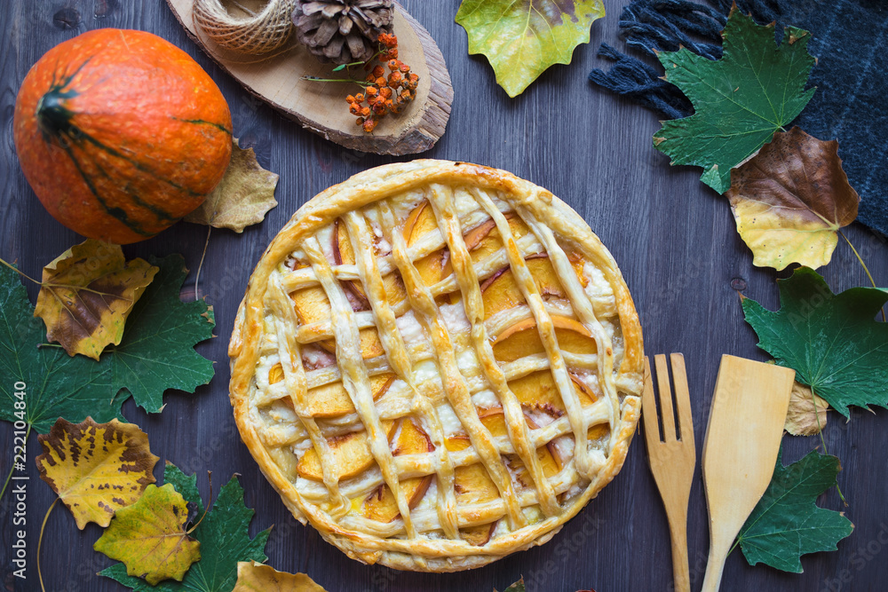Autumn concept. Pie with Peaches Pumpkin Autumn Foliage Tea Honey On a wooden background Autumn concept. Pie with Peaches Pumpkin Autumn Foliage Tea Honey On a wooden background