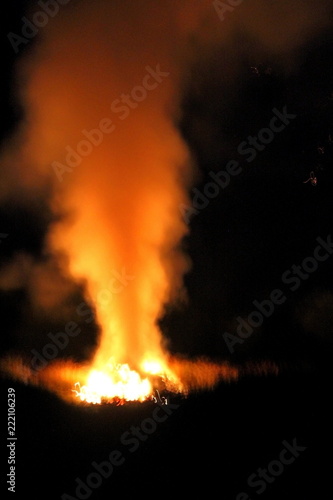 Fire at night in open space.