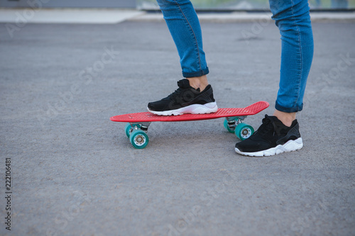 Some of the legs are on a skateboard close up. young sport. leisure. penny board © Юлия Буракова