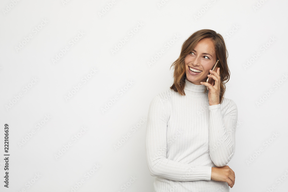 portrait of young beautyful woman on the phone looks left at copy space portrait of young beautyful woman on the phone looks left at copy space