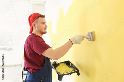 Male painter in uniform wor...
