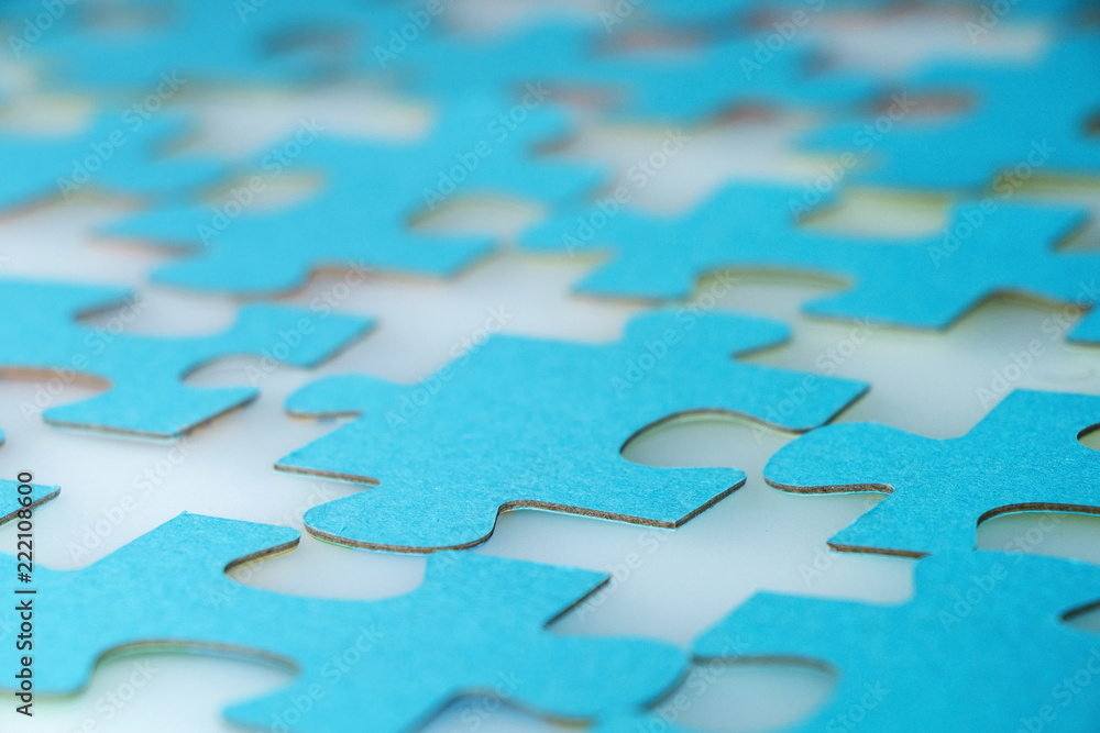 Elements of a puzzle of blue color on a white table. Elements of a puzzle of blue color on a white table.