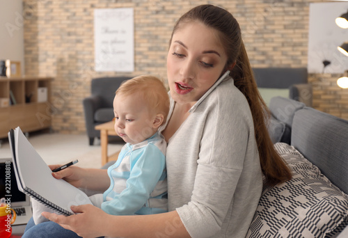 Young mother holding baby w...
