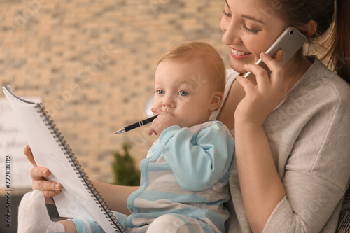 Young mother holding baby w...