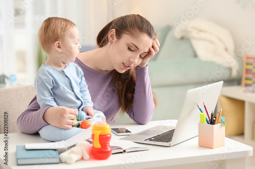 Young mother with baby work...