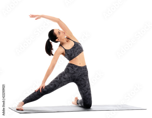 Young woman practicing yoga...
