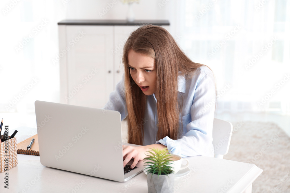 Female freelancer working on laptop in home office Female freelancer working on laptop in home office