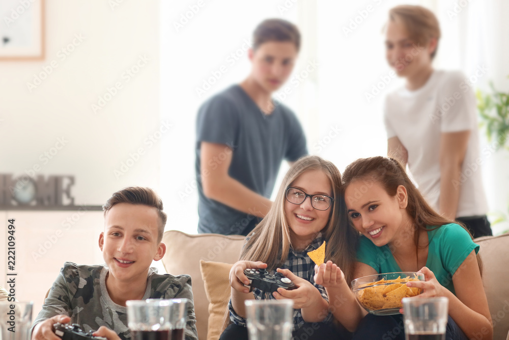 Teenagers playing video games at home Teenagers playing video games at home