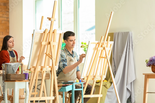 Group of people during classes in school of painters