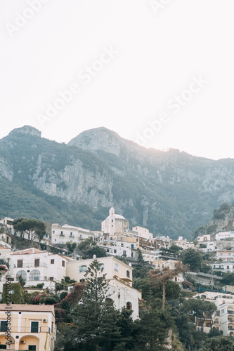 The coast of Positano  Amalfi in Italy. Panorama of the evening city and the streets with shops and cafes. Houses by the sea and the beach. Ancient architecture and temples