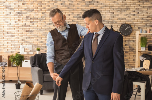 Mature tailor taking client...