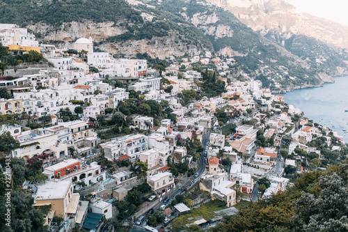 The coast of Positano, Amalfi in Italy. Panorama of the evening city and the streets with shops and cafes. Houses by the sea and the beach. Ancient architecture and temples © pavelvozmischev