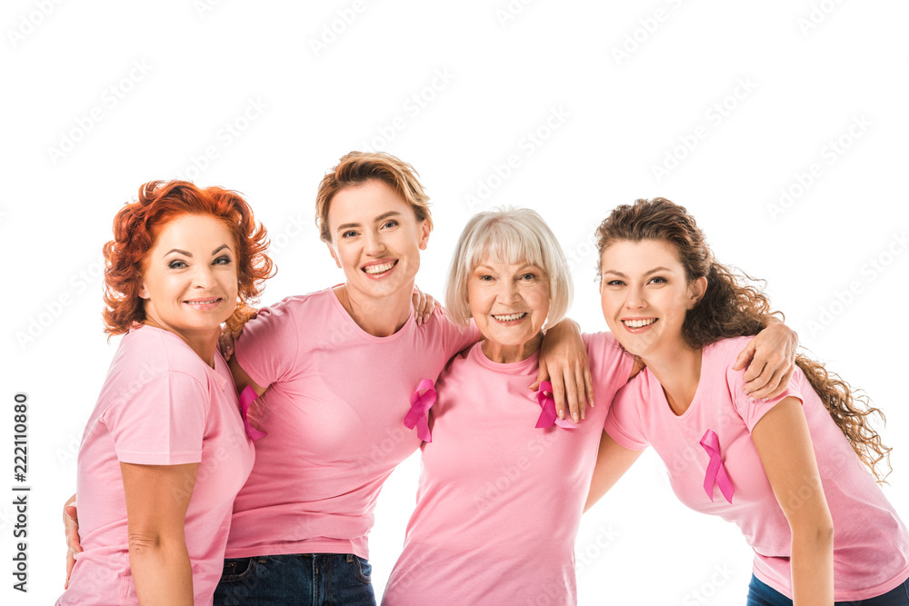 cheerful women in pink t-shirts with breast cancer awareness ribbons smiling at camera isolated on white cheerful women in pink t-shirts with breast cancer awareness ribbons smiling at camera isolated on white