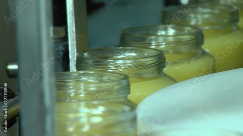 Full glass jars on an automatic production line. Modern Factory. photo