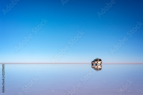 Mirror effect and reflections of a 4x4 car in Salar de Uyuni (Uyuni salt flats), Potosi, Bolivia, South America