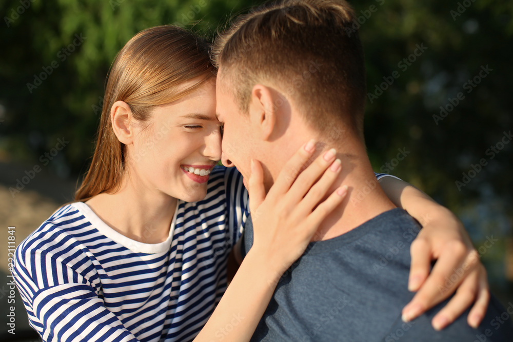 Obraz premium Young couple resting in park on sunny day