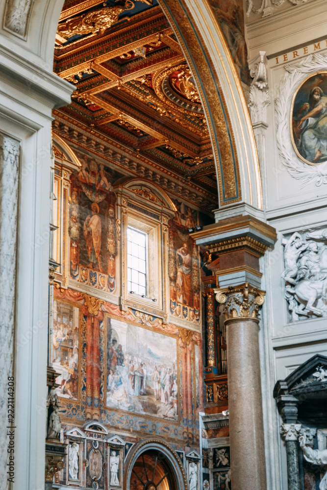 Naklejka premium Salvatore Church in Rome, view from outside and inside. Frescoes and statues, architectural elements. A historic landmark, tourist destination. Ancient painting