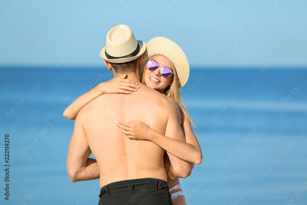 Happy young couple near sea on summer day Happy young couple near sea on summer day