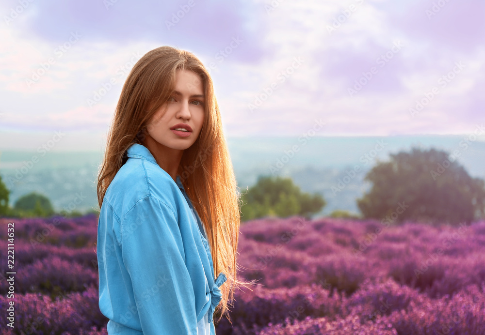 Beautiful young woman in lavender field on summer day Beautiful young woman in lavender field on summer day