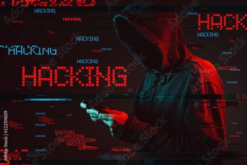 Computer hacking concept with faceless hooded male person