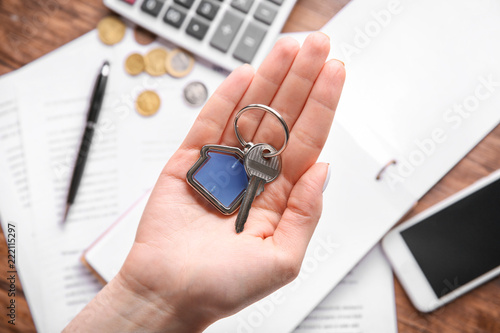 Woman holding key with trin...