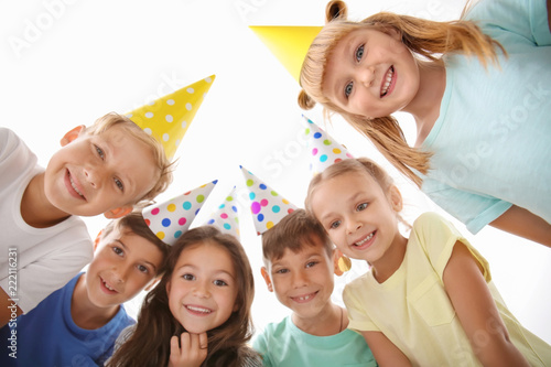 Cute little children in Birthday hats at party, bottom view