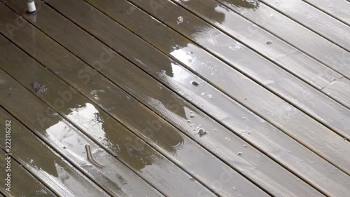 Rain falling on wooden deck_slomo photo