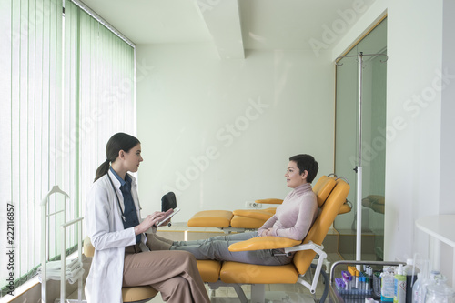 A Woman Physician Talking With Her Patient