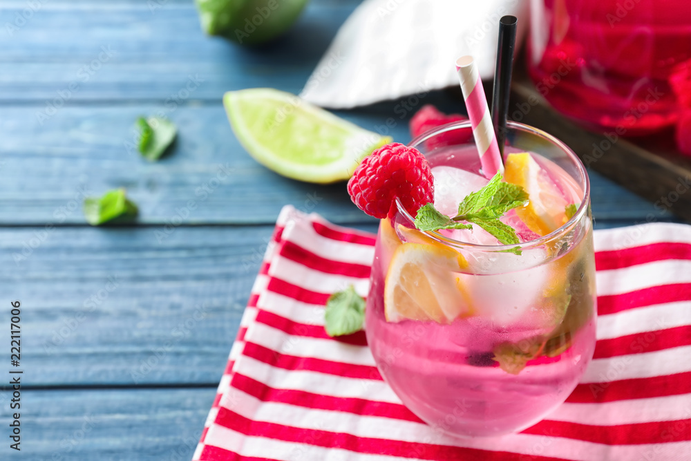 Glass of fresh raspberry mojito on wooden table Glass of fresh raspberry mojito on wooden table