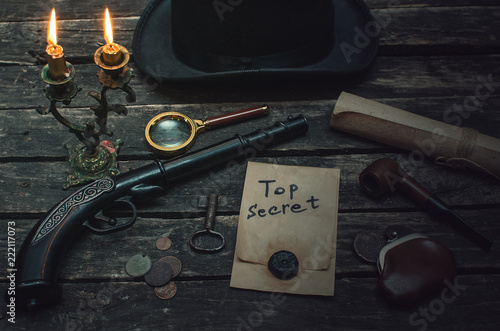 Top secret documents file, magnifying glass, smoking pipe, bowler hat and wallet with coins on the detective spy agent.