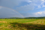 rainbow in the field against the beautiful sky