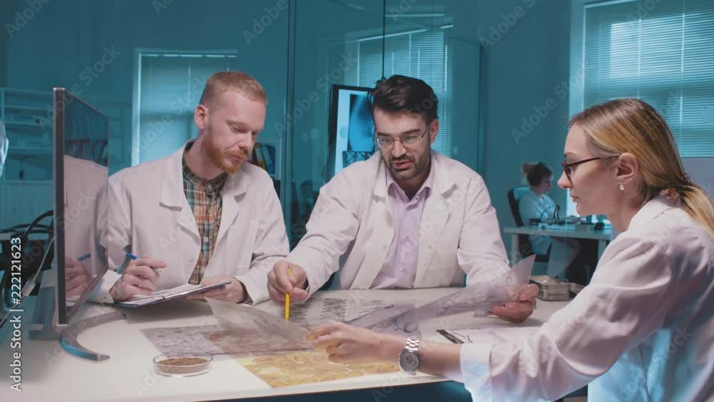 Group of scientists discuss the effect of new drug