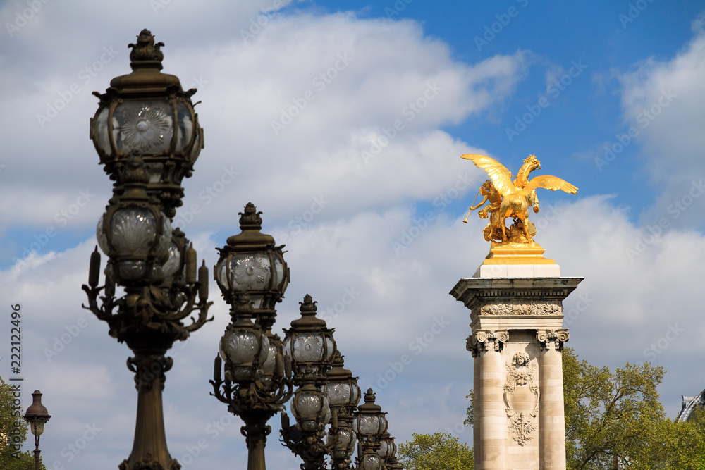 Ornate lanterns and statue at the Pont Alexandre III in Paris, France Ornate lanterns and statue at the Pont Alexandre III in Paris, France