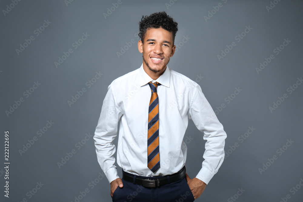 Handsome African-American businessman on grey background Handsome African-American businessman on grey background