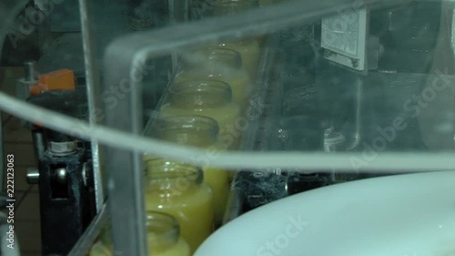 Glass jars with compote on an automatic production line. Modern factory. photo