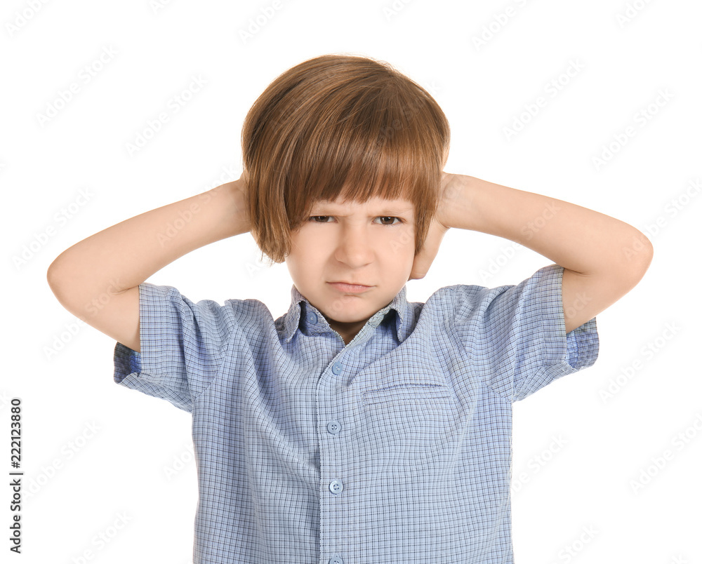 Emotional little boy covering ears with hands on white background Emotional little boy covering ears with hands on white background