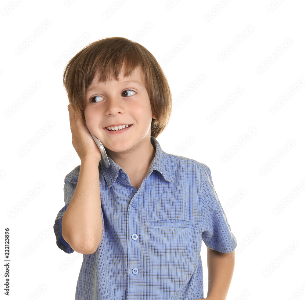 Cute little boy talking on mobile phone against white background Cute little boy talking on mobile phone against white background