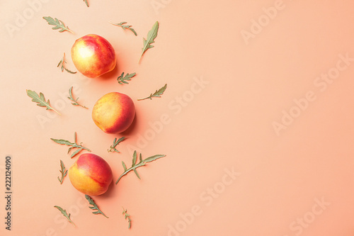 Composition with ripe peaches on color background, top view