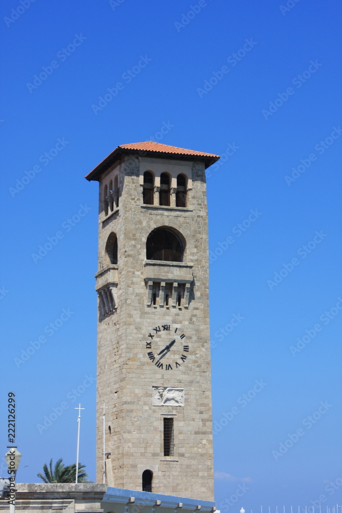 Evangelist Kilisesi orthodox church (Ekklisia Evaggelismos) - the tower clock on Rhodes, Greece. Evangelist Kilisesi orthodox church (Ekklisia Evaggelismos) - the tower clock on Rhodes, Greece.