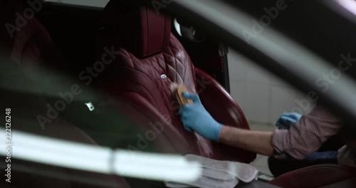 Detailing and cleaning of interior front seats at luxury modern cars. Car care concept photo