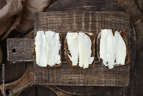 Butter Black rye bread Sandwiches on a wooden cutting board