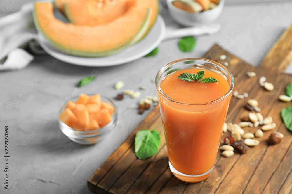 Glass with delicious melon smoothie on board Glass with delicious melon smoothie on board