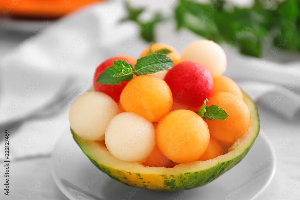 Bowl with fresh melon and watermelon balls on light table Bowl with fresh melon and watermelon balls on light table