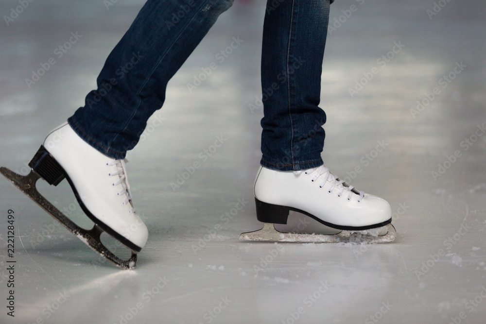 Close-up of Legs in Skates on Skating Rink