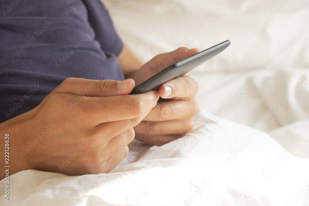 man using a tablet or an e-reader in bed man using a tablet or an e-reader in bed
