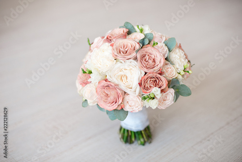 close-up elegant bouquet of flowers with roses diathus carnation bohemia chrysantemum on light background indoors. photo