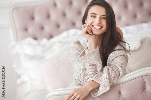 Young beautiful woman indoors. Portrait of attractive woman in knitted clothes.