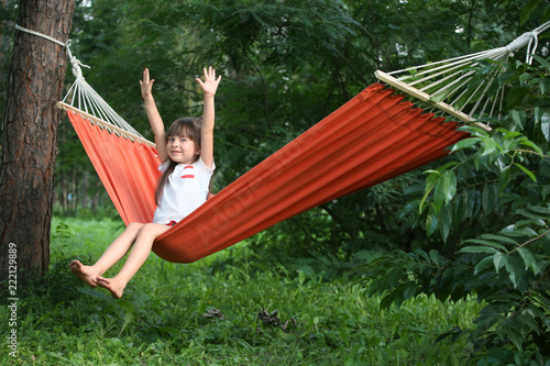 Cute little girl relaxing in hammock on summer day © Pixel-Shot
