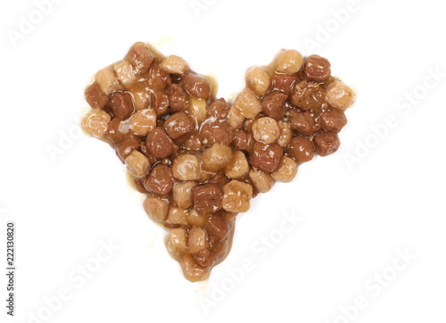 Cat food in heart shape isolated on white background, top view